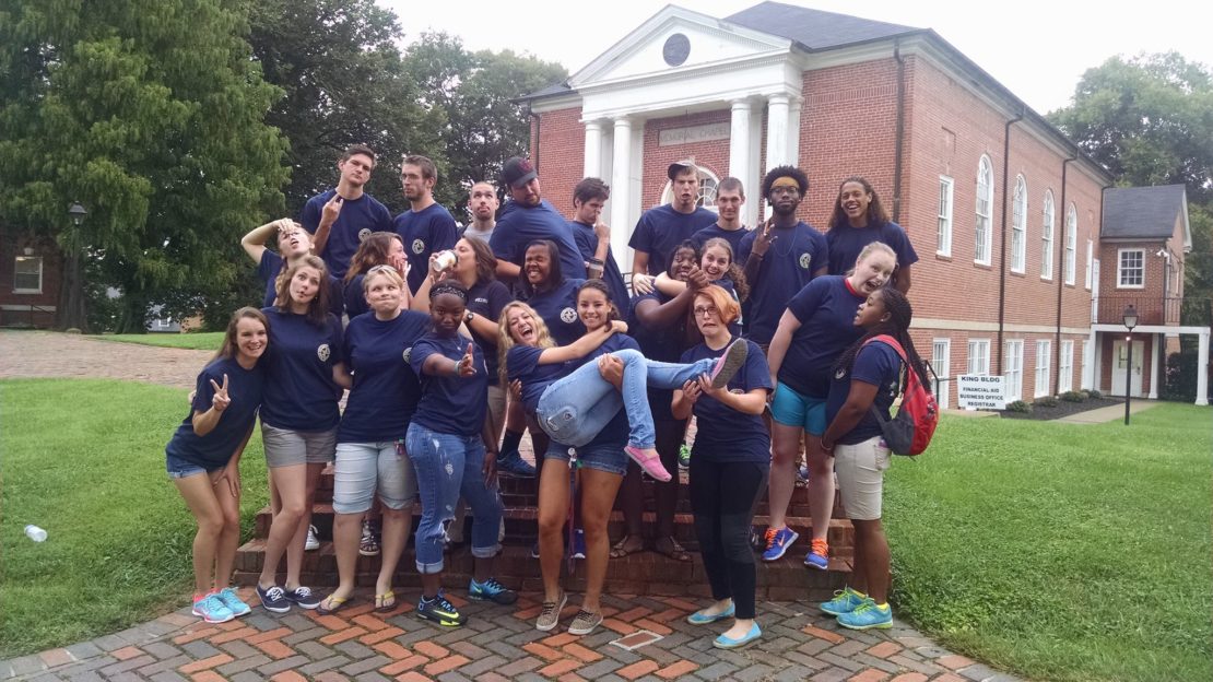 Students make silly pose outside chapel