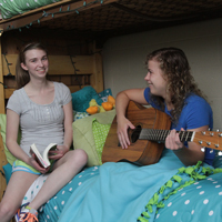 King University students sitting on a bunk bed in dorm room
