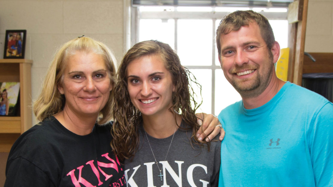 student with her parents