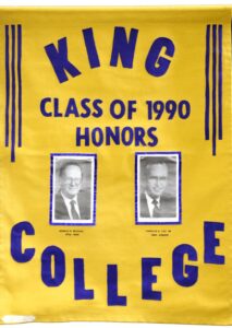 A yellow banner reads King College Class of 1990 Honors in blue letters, with two black-and-white portraits of men underneath. The names Donald B. Windsor and Charles C. Can Hil appear below their respective photos.